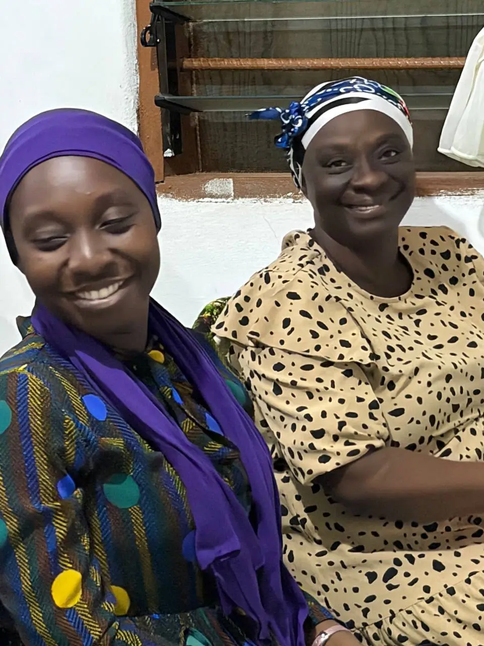 Two members smiling together after service